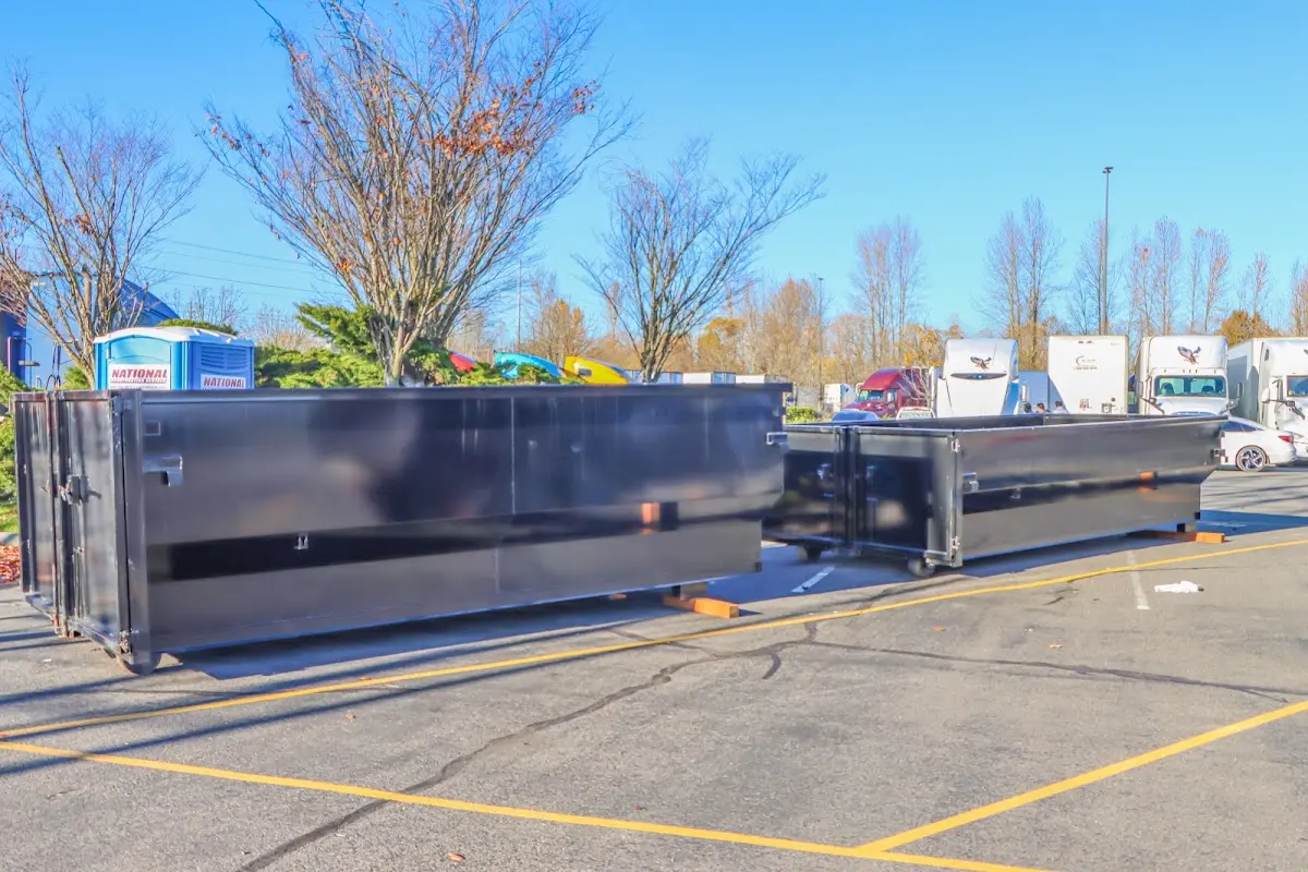 Professional dumpster rental service with roll-off container on residential driveway in Winnetka